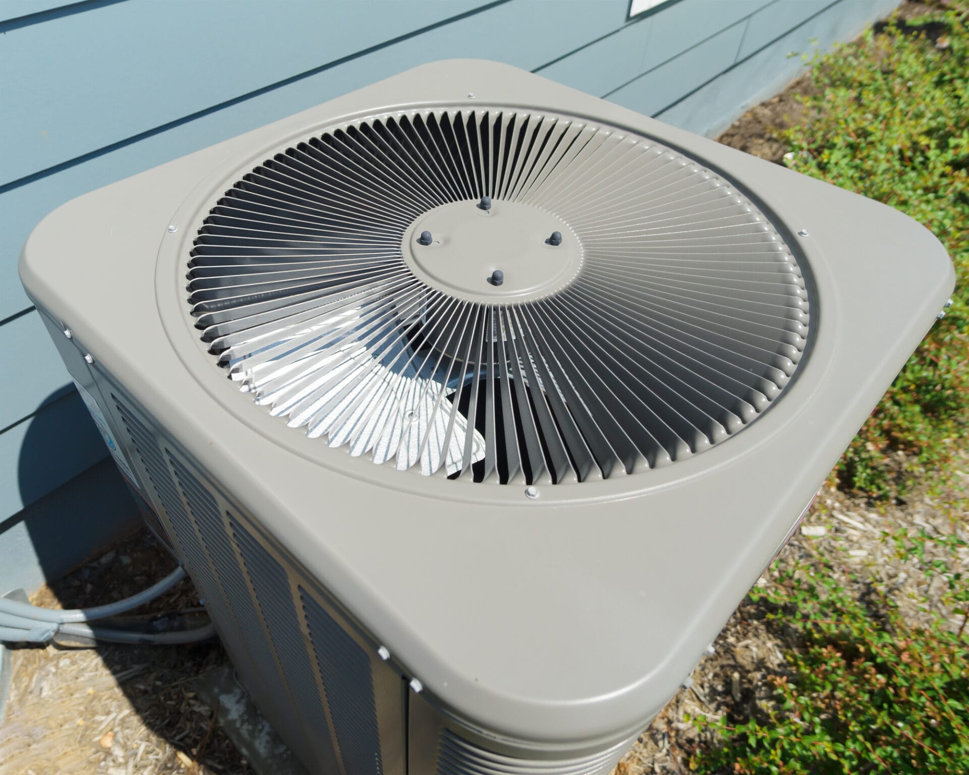 Central air conditioning unit fan outside a home