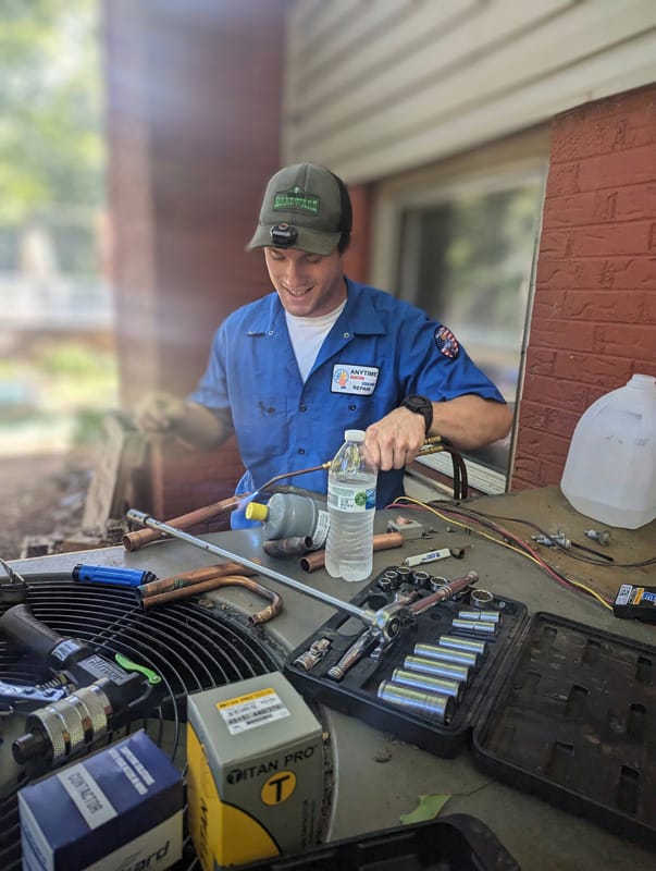 A technician repairing HVAC equipment.