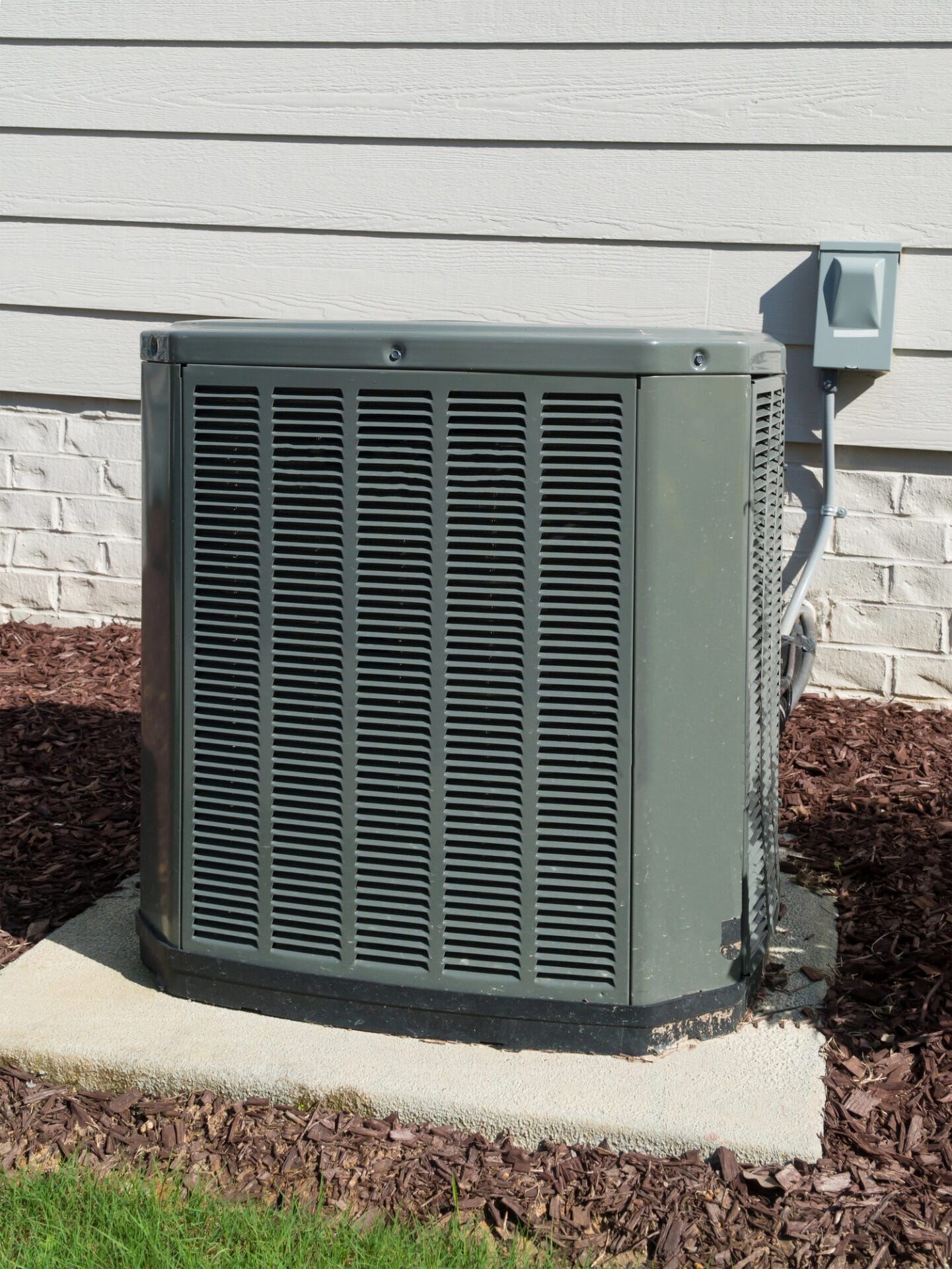 Residential central air conditioning unit installed outside a home.