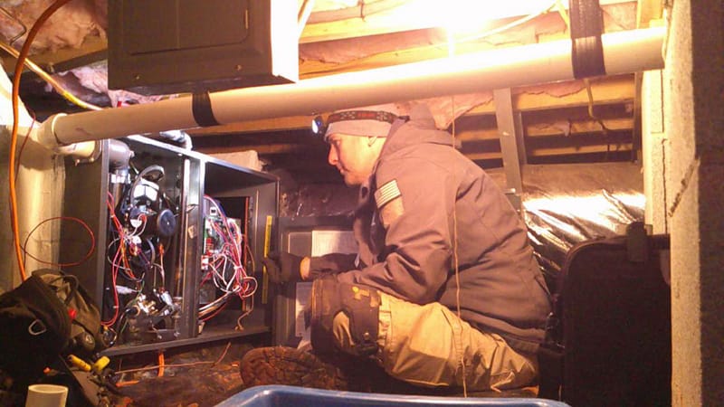 A man working on a furnace